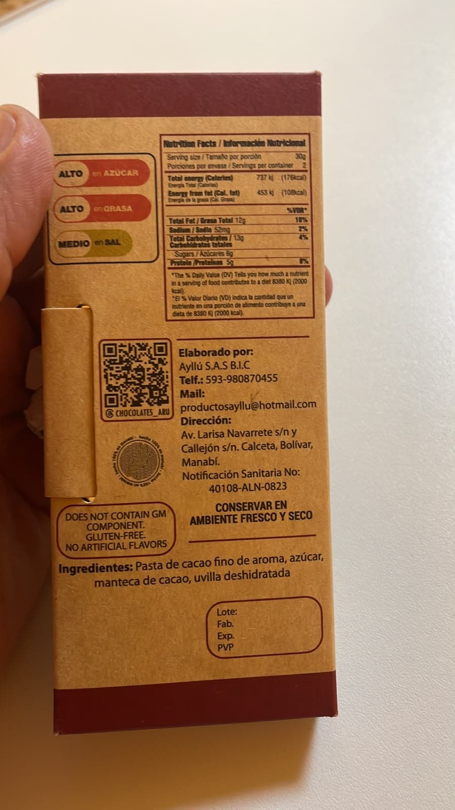 Back of an Arú chocolate bar showing nutrition facts, ingredients, producer information, and Ecuadorian labeling.